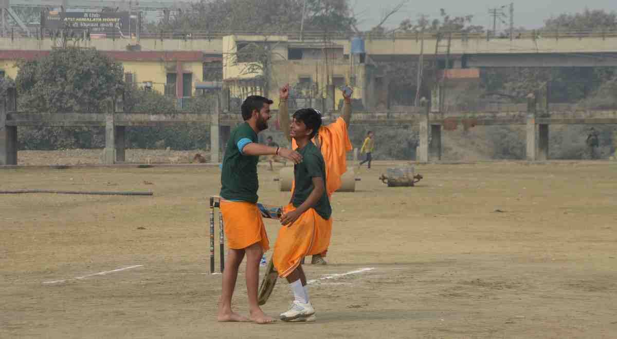 Student playing cricket match in dhoti kurta in varanasi