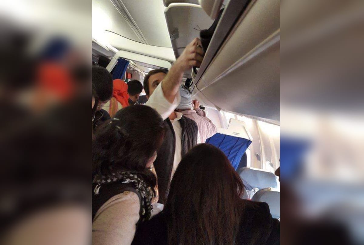 rahul gandhi helps his co passenger in a flight in keeping their luggage in overhead cabin