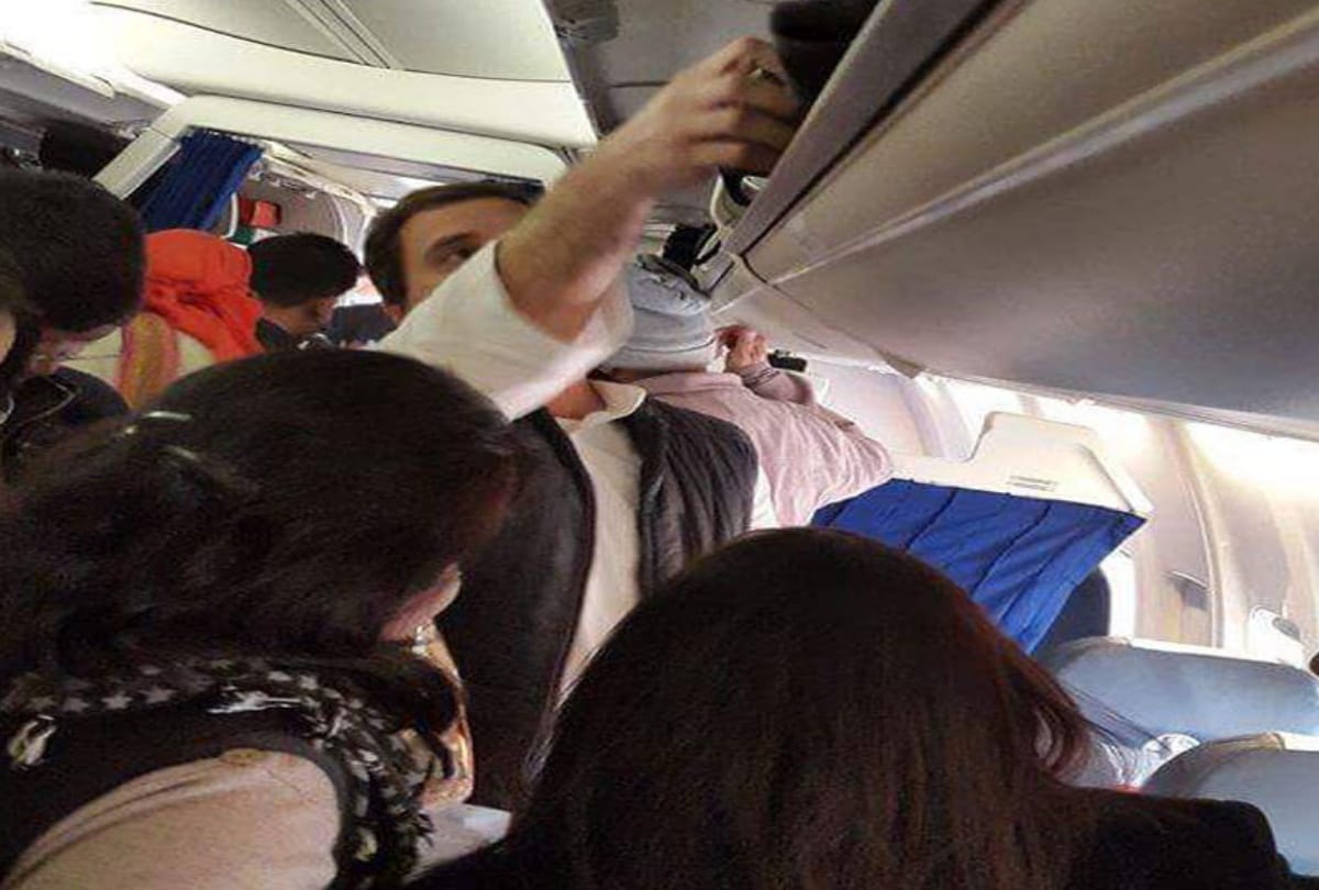 rahul gandhi helps his co passenger in a flight in keeping their luggage in overhead cabin