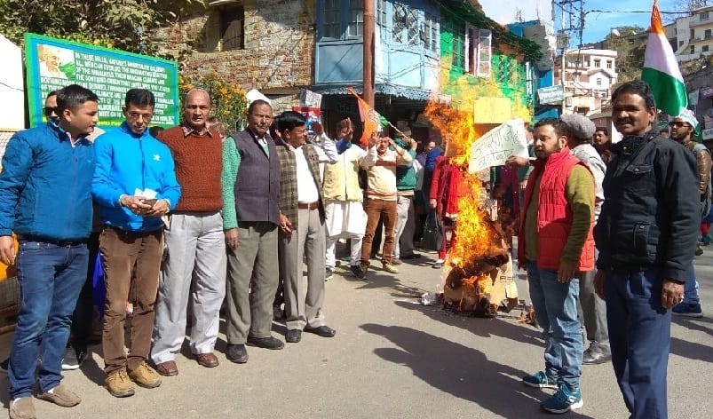 Congress workers blow the effigy of central government