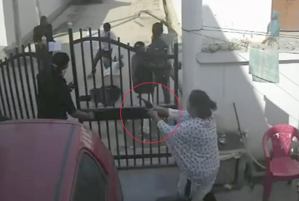 A woman fired on attackers who were beating her husband.