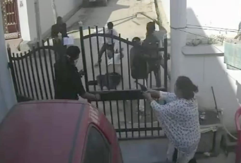 A woman fired on attackers who were beating her husband.