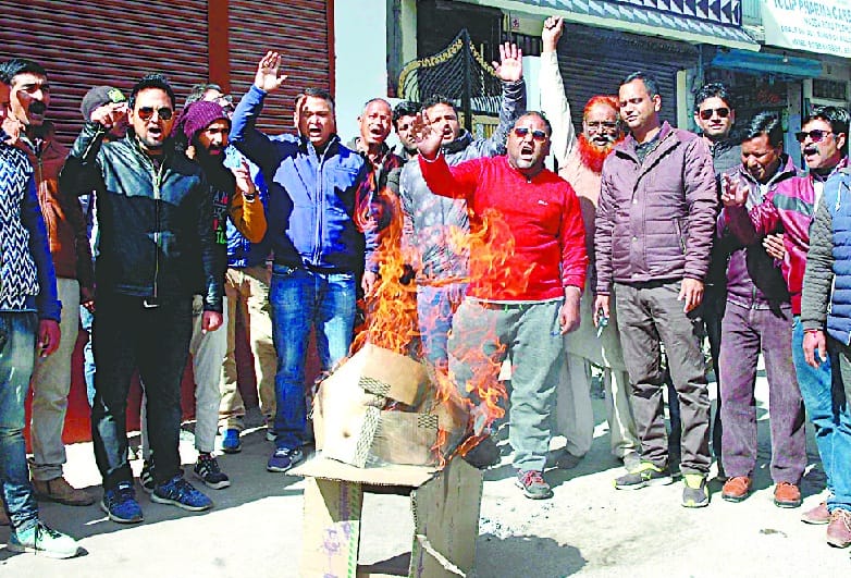 Congressmen blow the effigy of Prime Minister Narendra Modi