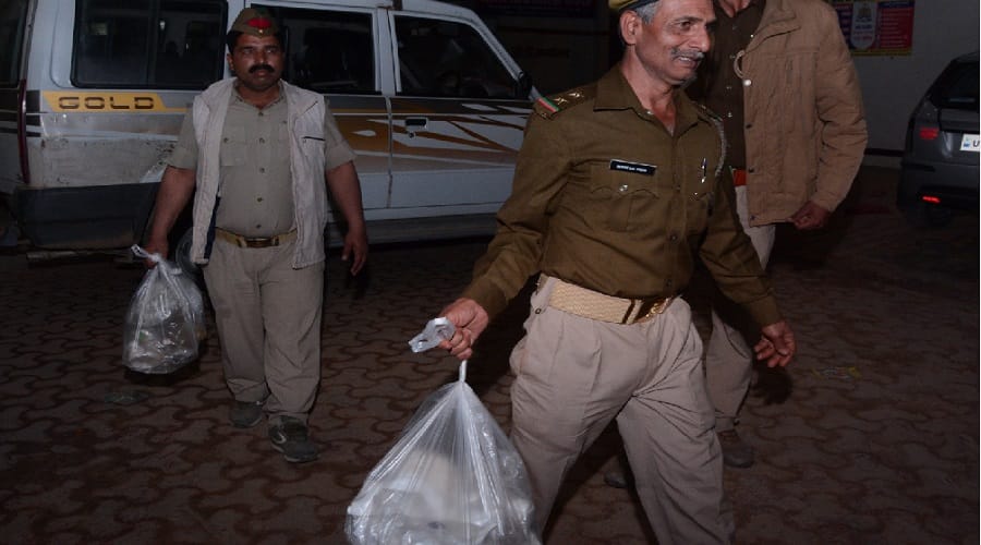 Surprised officials watching the suspicious parts of wild animals in the worship material shop
