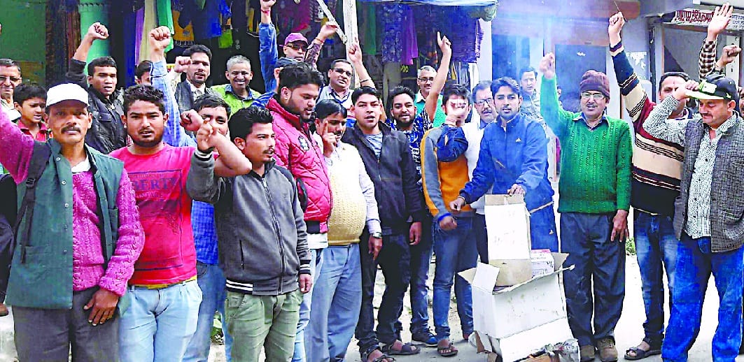 People blow the effigy of power department