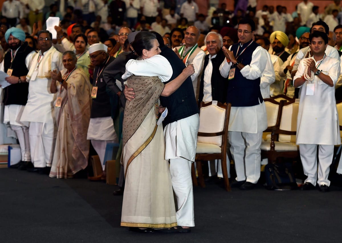 Congress plenary session: sonia gandhi hugs rahul gandhi after attacks modi government