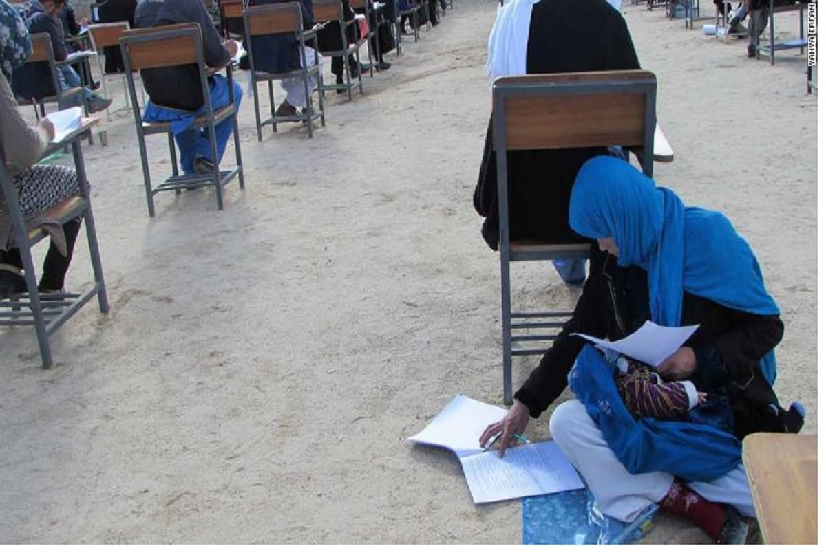 Inspiring photo of Afghan woman taking university exam while nursing child goes viral