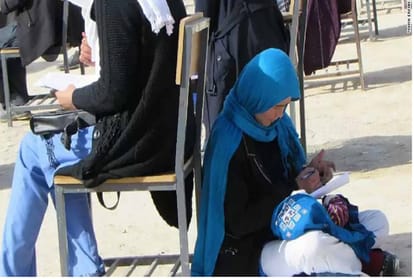 Inspiring photo of Afghan woman taking university exam while nursing child goes viral