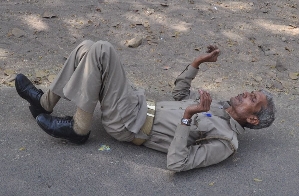 policeman lying on the road in agra