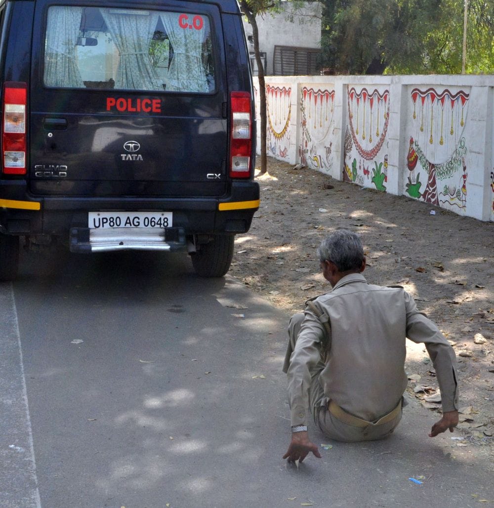 policeman lying on the road in agra