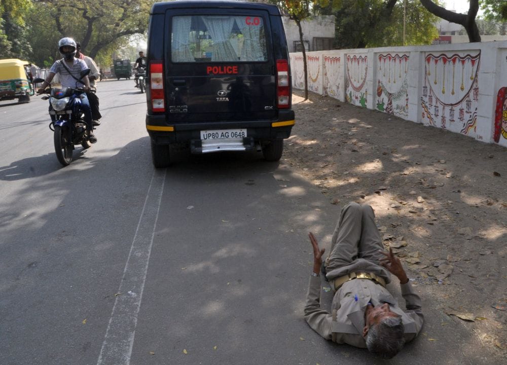 policeman lying on the road in agra