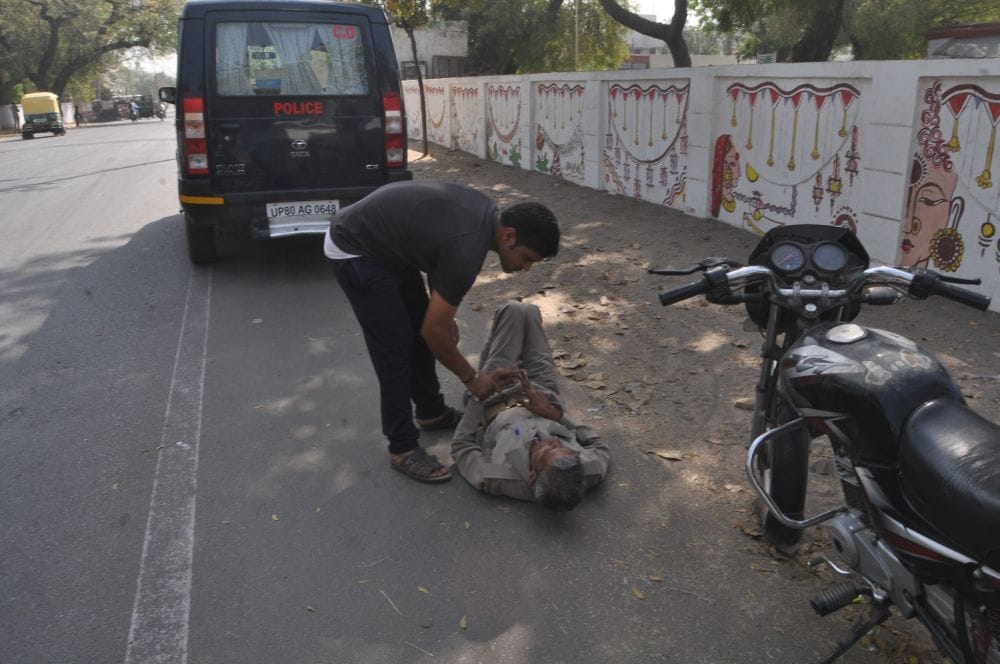 policeman lying on the road in agra