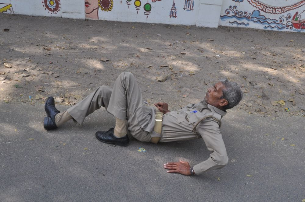 policeman lying on the road in agra