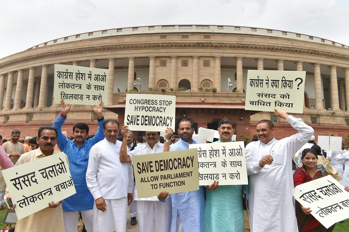  BJP MPs protest against congress in parliament premises for washed out of session