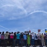 Chennai: Foreign visitors look at a model of Sukhoi Su-30 on DefExpo 2018