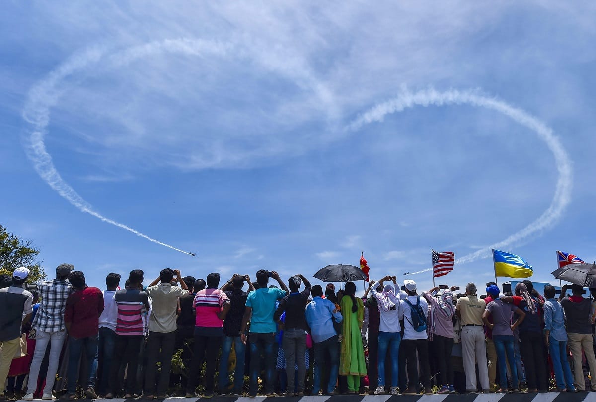 Chennai: Foreign visitors look at a model of Sukhoi Su-30 on DefExpo 2018