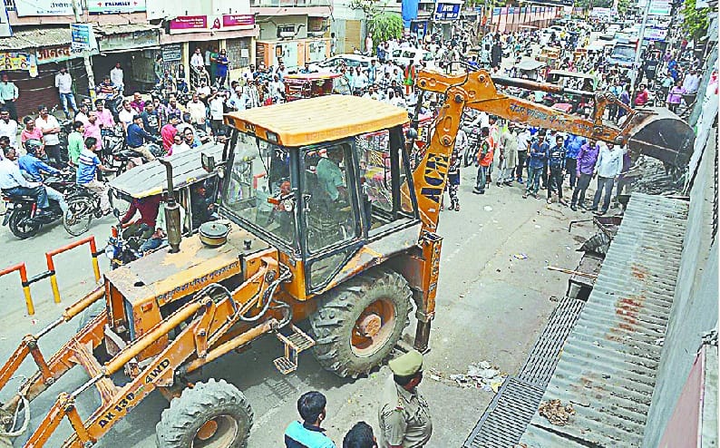 JCB stops in front of Holly Angeles, Sindhi Medical Hall