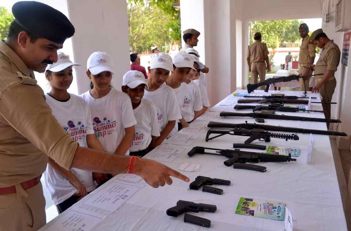 Children take information about AK 47 to rifle and pistol in summer camp