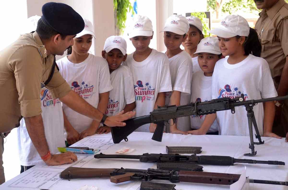 Children take information about AK 47 to rifle and pistol in summer camp