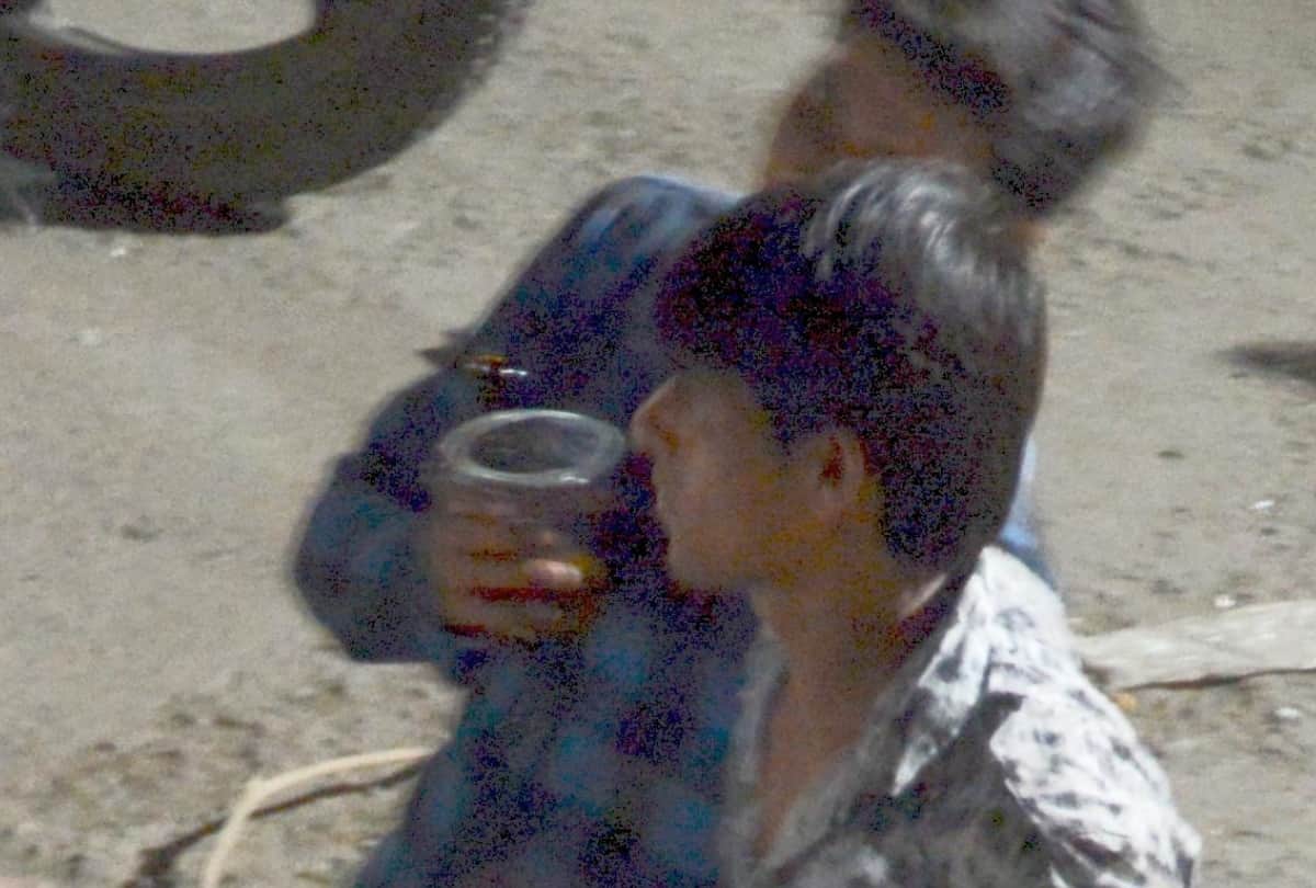 men are drinking wine on road in lucknow