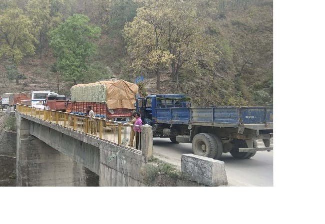 Loaded vehicles standing on the bridge while jam