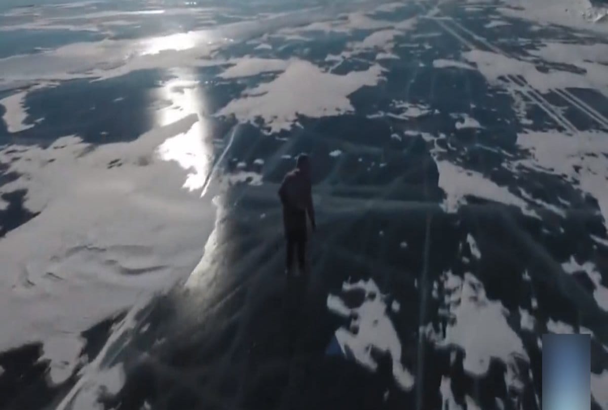seventy years old grandma ice skates over a frozen lake in Siberia