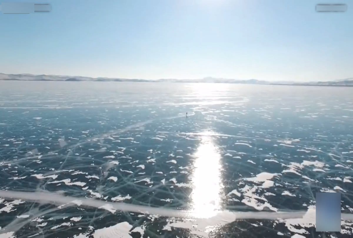 seventy years old grandma ice skates over a frozen lake in Siberia