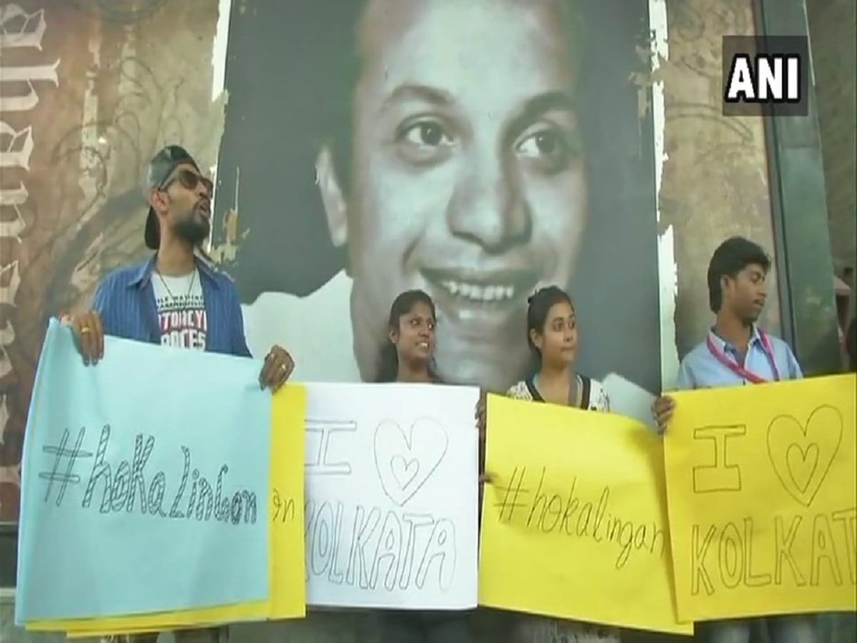 youngsters offer 'free hugs' to people at outside dum dum metro station as a mark of protest