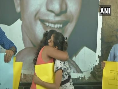 youngsters offer 'free hugs' to people at outside dum dum metro station as a mark of protest