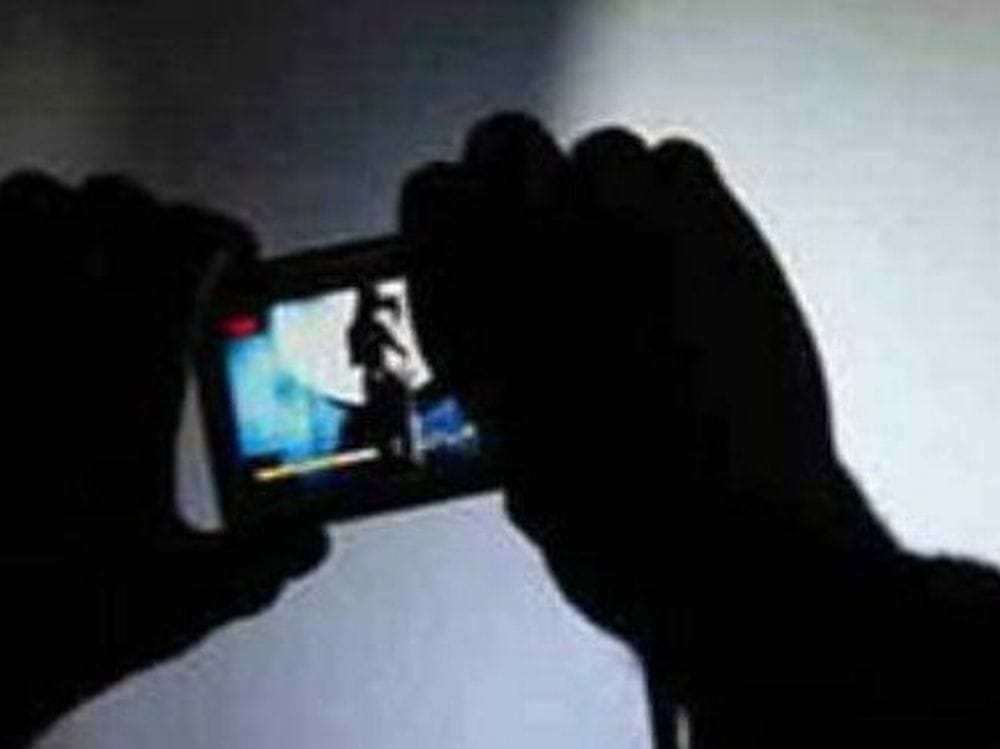 Youth clicking photo of girl in house 