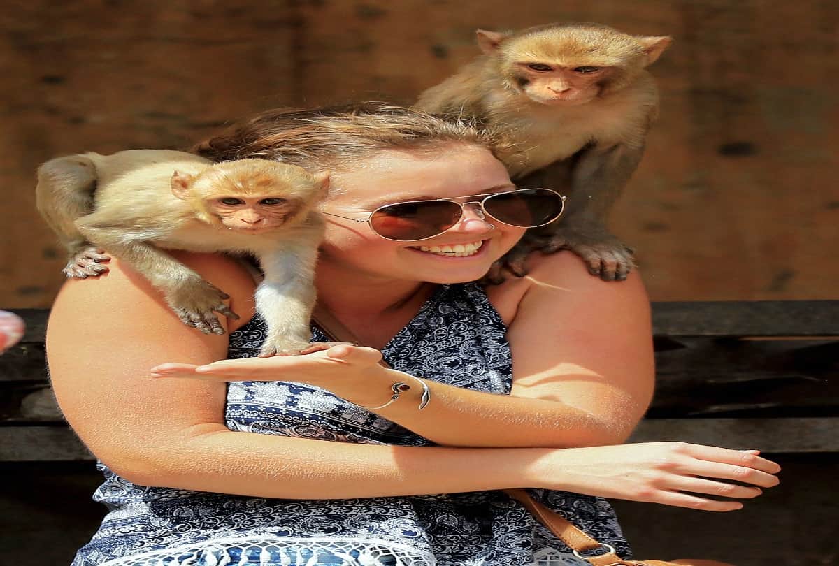 A tourist poses for a photo as in hot, summer day at Galta temple in Jaipur