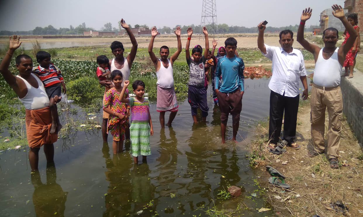 Standing in dirty water and performing