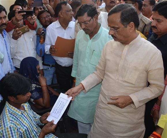 Dy CM handed over checks to family members of deceased three people