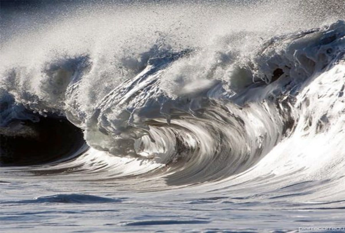 A Daredevil athlete balance between high waves in the storm