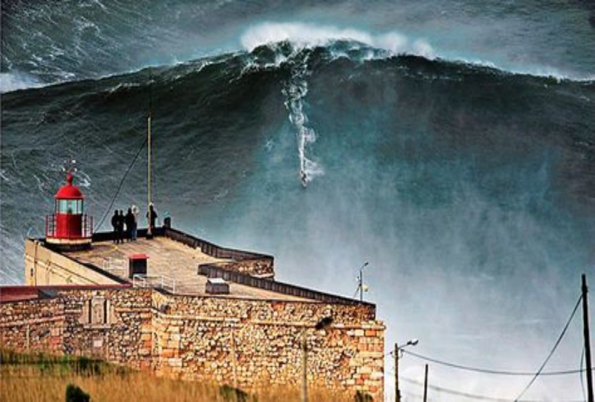 A Daredevil athlete balance between high waves in the storm