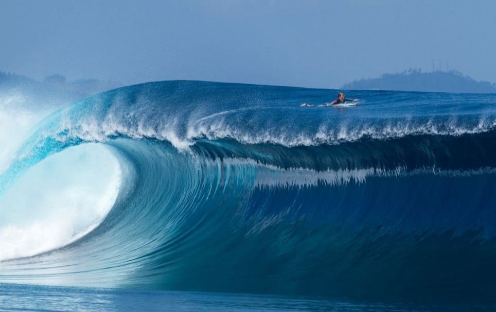 A Daredevil athlete balance between high waves in the storm