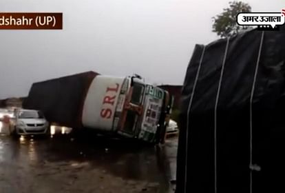  Vehicles trapped under trucks after they overturn due to massive storm