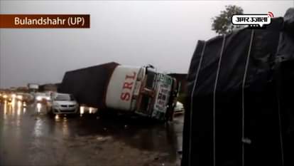  Vehicles trapped under trucks after they overturn due to massive storm