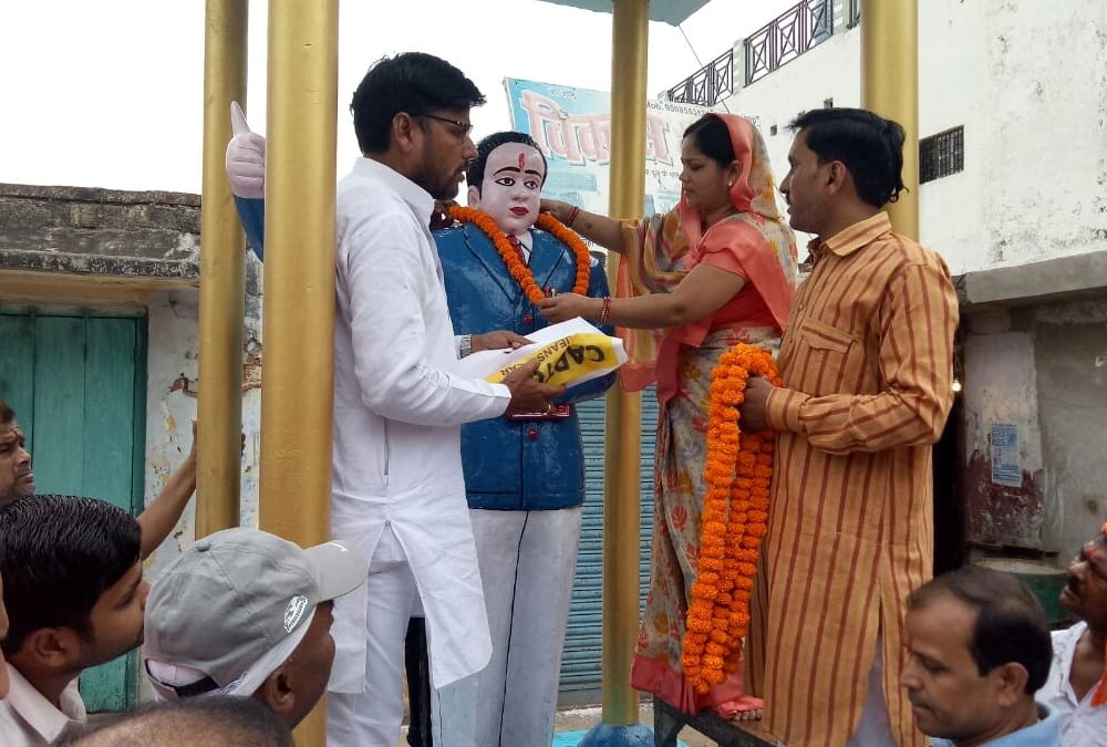 BJP MLA put on saffron clothes on ambedkar statue.