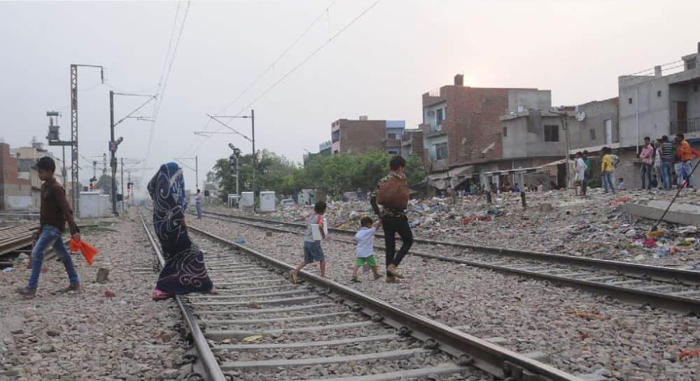 people cross railway crossings in agra 