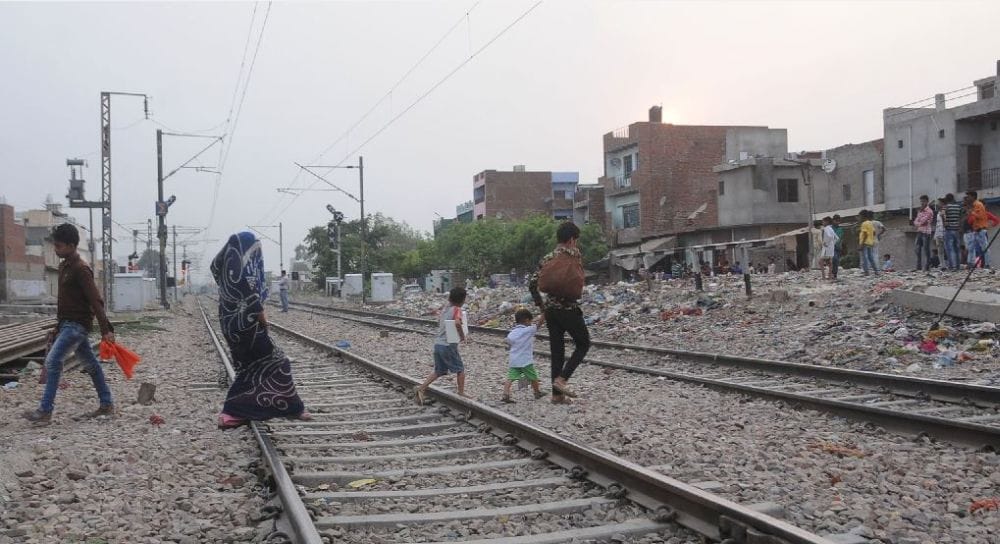 people cross railway crossings in agra 