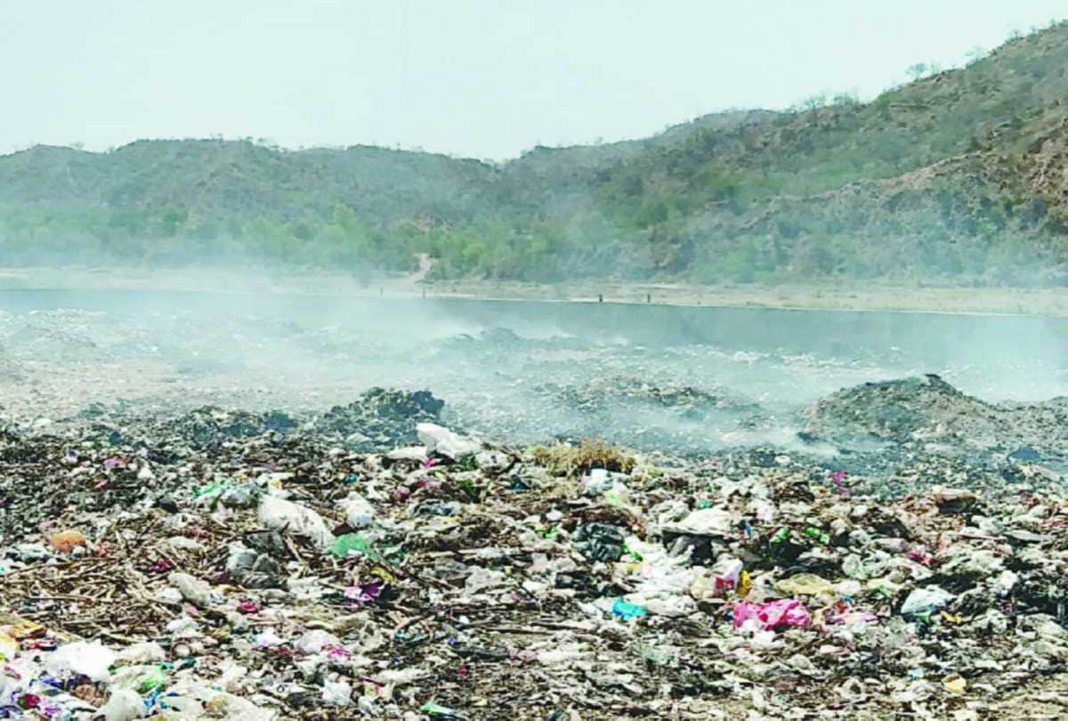 Youths done yoga near garbage on international yoga day 