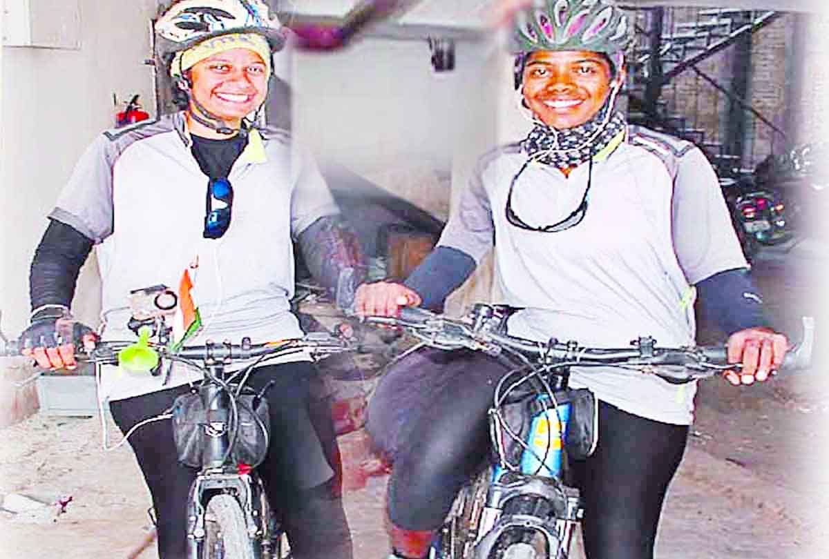 Two girls on a bicycle trip to give message to stop women violence