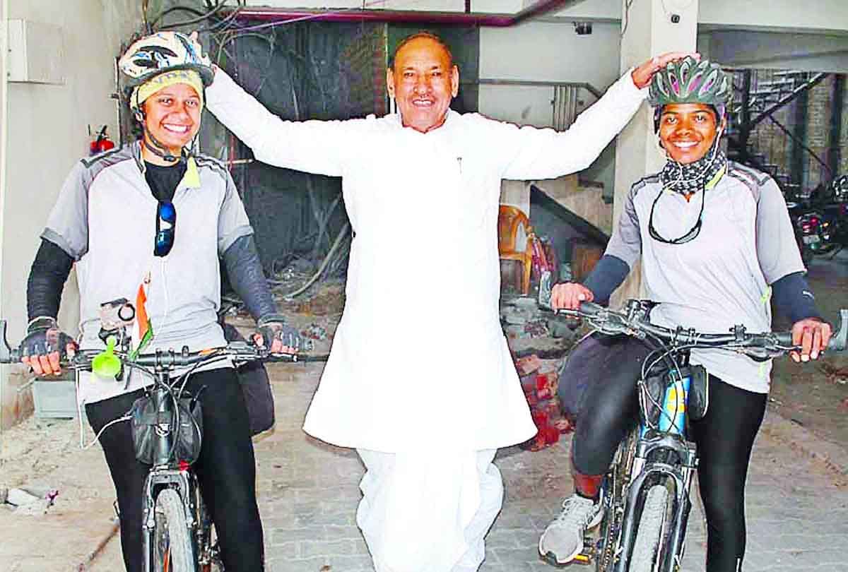 Two girls on a bicycle trip to give message to stop women violence