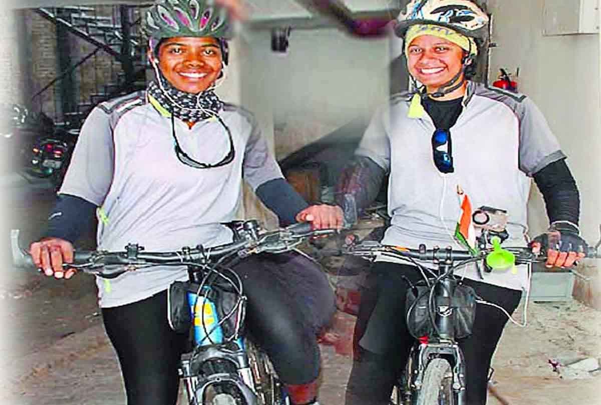 Two girls on a bicycle trip to give message to stop women violence