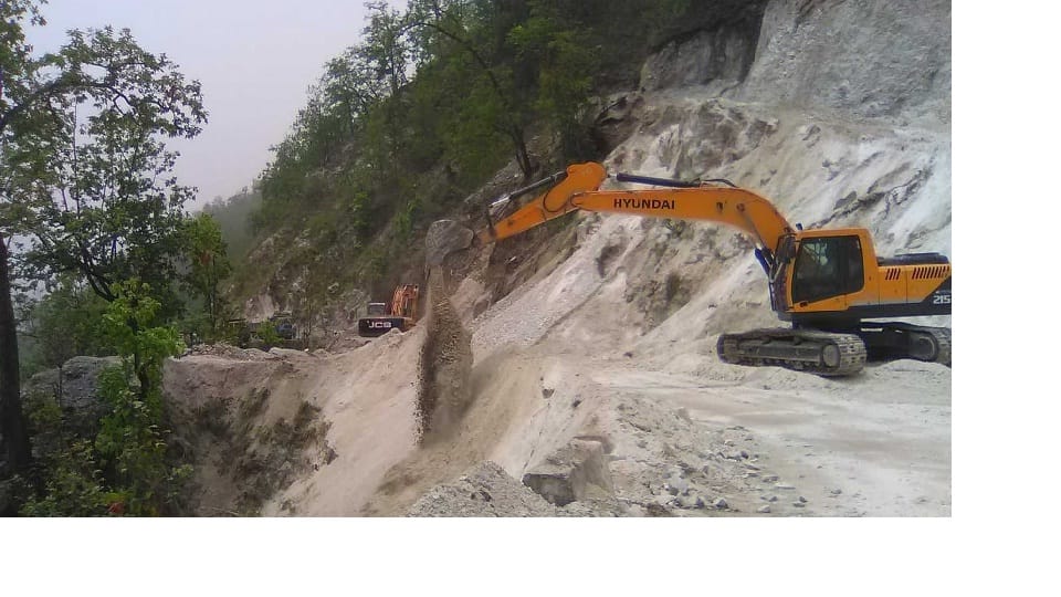 Road debris being inserted into the trench