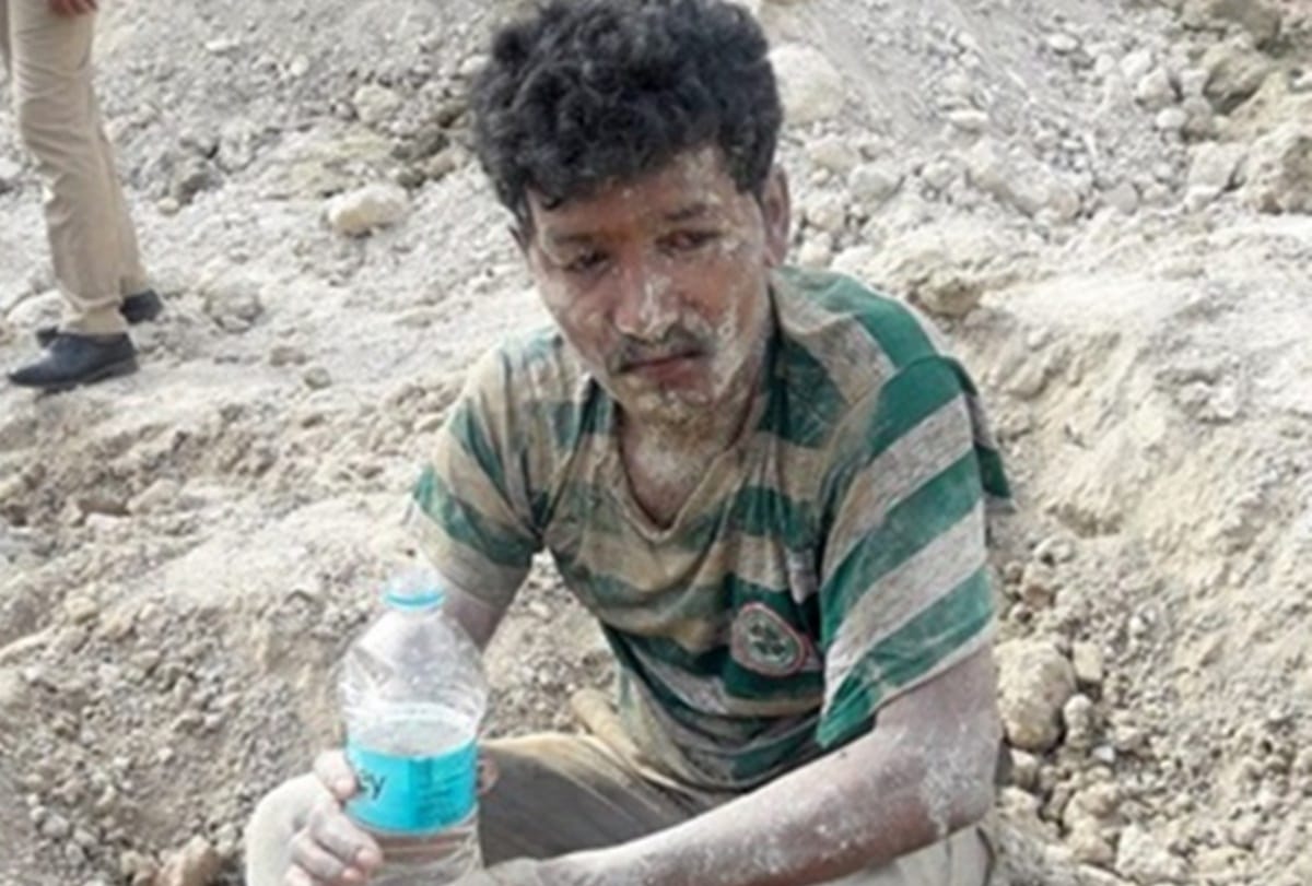 man was sleeping when dumper puts lots of mud on the man and police took him out safely