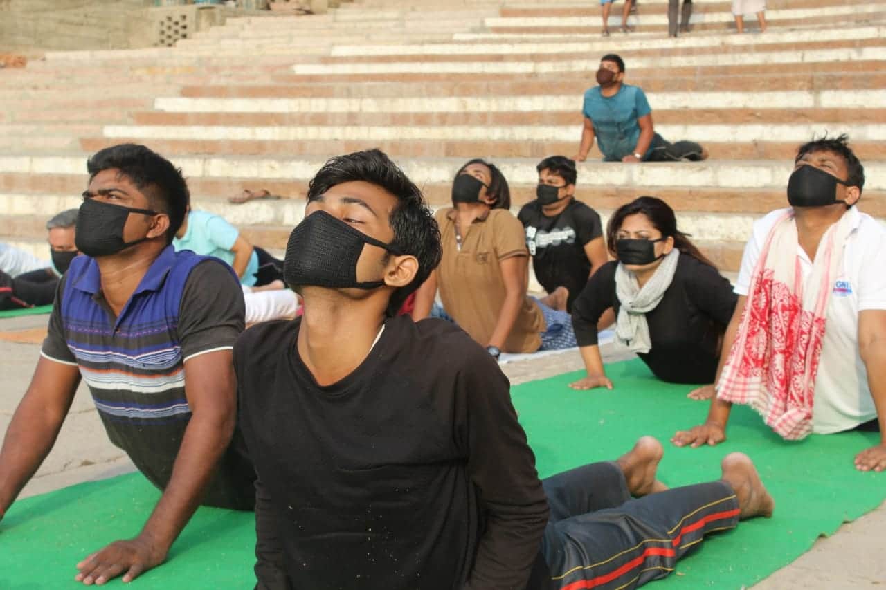 International yoga day people do yoga in mask due to air pollution
