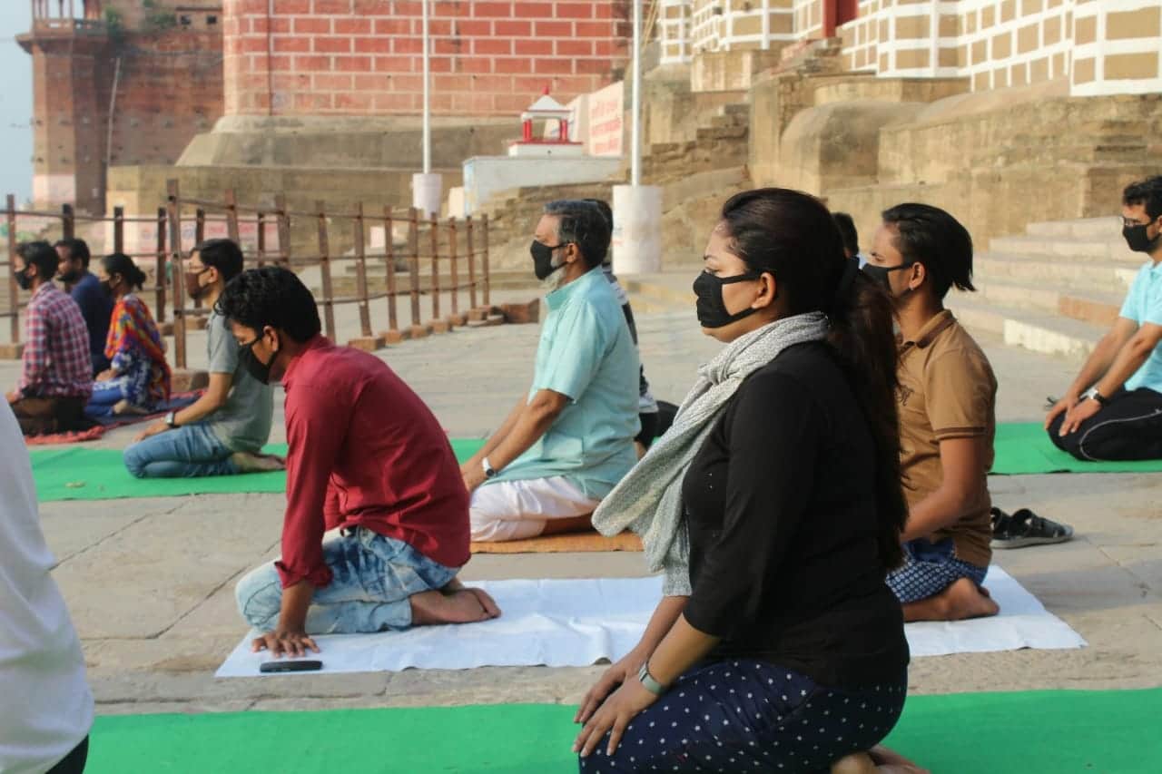 International yoga day people do yoga in mask due to air pollution
