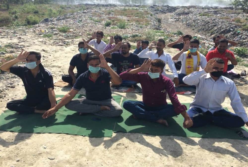 Youths done yoga near garbage on international yoga day 